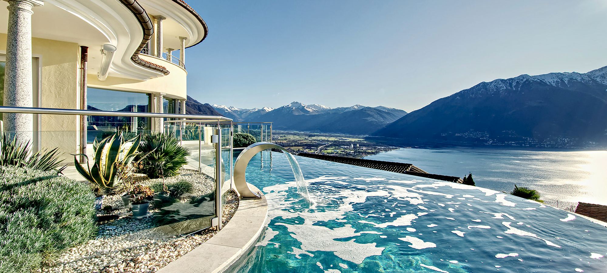 Infinity pool overlooking a Swiss lake and mountains